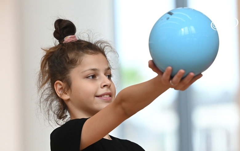 Karolina Tarasova does an exercise with a ball