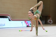 Daria Prikhodko in a low ring exercise with clubs