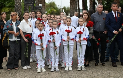Academy students laid flowers to the Memorial Sign for workers of the Southern Crops state-owned farm
