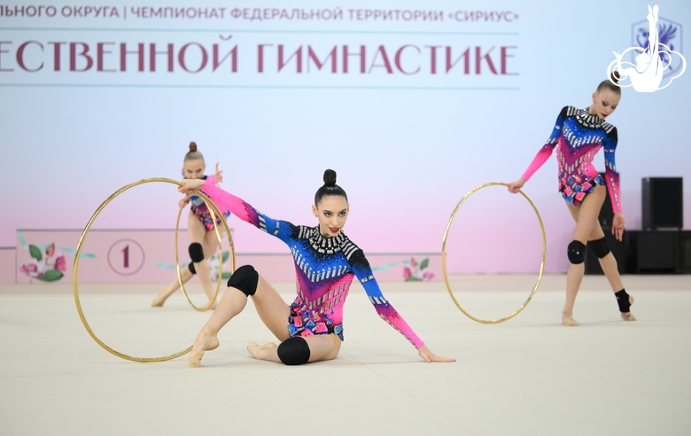 Academy group gymnasts during exercise with hoops