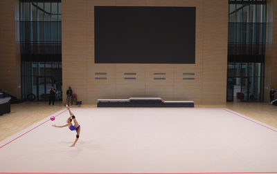 Alina Kabaeva, along with coaches, analyzes the elements that Yana Zaikina struggled with during her run-through