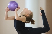 Young gymnast during the ball exercise