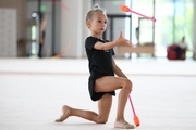 Young gymnast performing a club routine