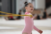 Young gymnast during an exercise with a jump rope