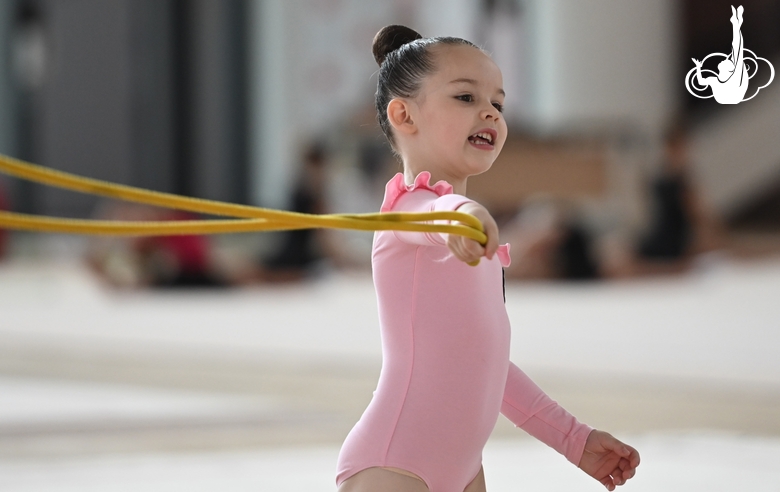 Young gymnast during an exercise with a jump rope