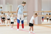 Academy coach Olga Frolova with young gymnasts during a lesson