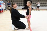 Olympic champion Alina Kabaeva with a young gymnast during the selection process into the Academy