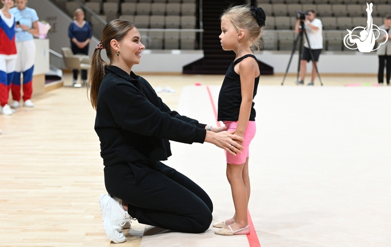 Olympic champion Alina Kabaeva with a young gymnast during the selection process into the Academy