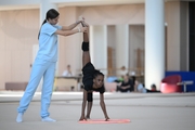 Academy coach Elizaveta Chernova with gymnast Nkenko Sita Davina Chanselvi during the hoop exercise