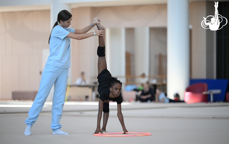 Academy coach Elizaveta Chernova with gymnast Nkenko Sita Davina Chanselvi during the hoop exercise