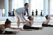 Academy Coach Elizaveta Chernova and gymnasts from China during the training session