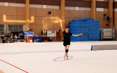 Olympic champion Alina Kabaeva shows Mariia Borisova the correct entry into a leap for a hoop catch