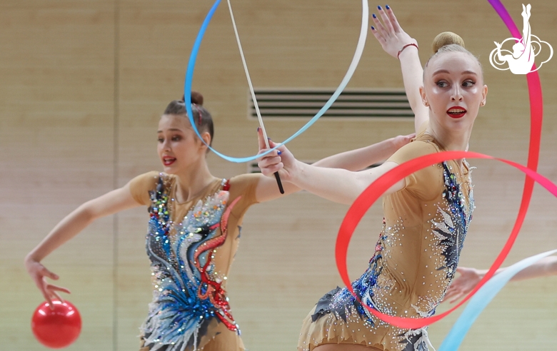 Gymnasts during an exercise with balls and ribbons