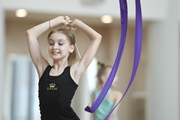 Gymnast performs an exercise with a ribbon at training