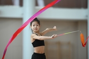 Chinese gymnast performs an exercise with a ribbon