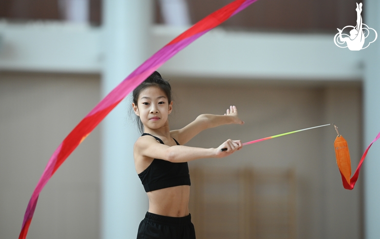 Chinese gymnast performs an exercise with a ribbon