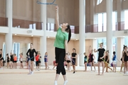 Gymnasts with a coach during class