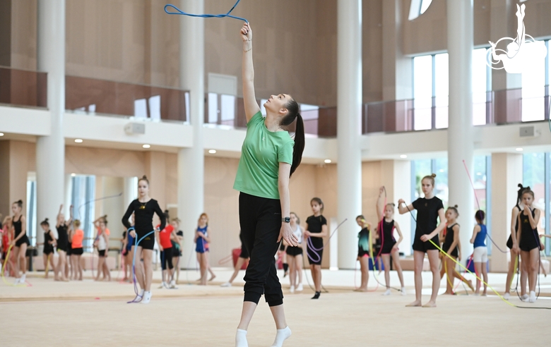 Gymnasts with a coach during class