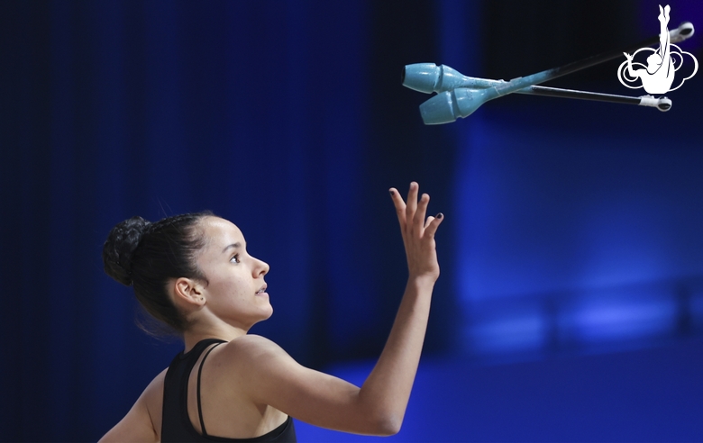 Isabella Rojas during an exercise with clubs at floor testing