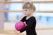 Young gymnast during the ball exercise