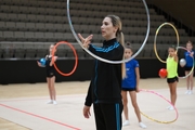 Coach Olga Frolova with gymnasts during practice at the training camp in the Academy