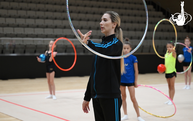 Coach Olga Frolova with gymnasts during practice at the training camp in the Academy