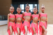 Young rhythmic gymnasts in leotards after at the assessment training session