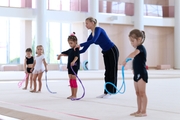 Coach Elizaveta Zorkina and young gymnasts during training