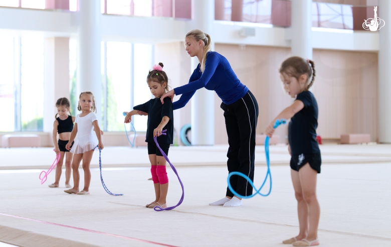 Coach Elizaveta Zorkina and young gymnasts during training