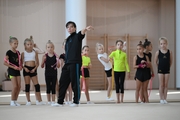 Coach Olesya Kovaleva with gymnasts during practice at the training camp in the Academy