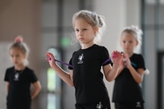 Young gymnast performing a club routine