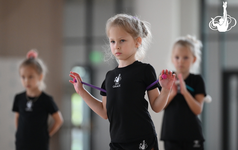 Young gymnast performing a club routine