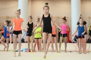 Gymnasts during an the exercises with a jump rope at training