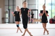 Young gymnasts performing a club routine