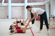 Coach Elizaveta Chernova and young gymnasts during a training