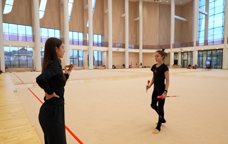 Arina Kovshova works out a risk with clubs with the Olympic champion