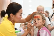 Young Academy guest in the face painting area