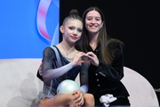 Arina Kovshova with coach Elizaveta Chernova after an exercise with a ball