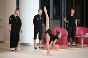 Academy coach Evgeniy Eliseeva, Dina and Arina Averina with Diana Solosina during training