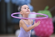 Young gymnast during an exercise with a hoop at the mAlinka tournament