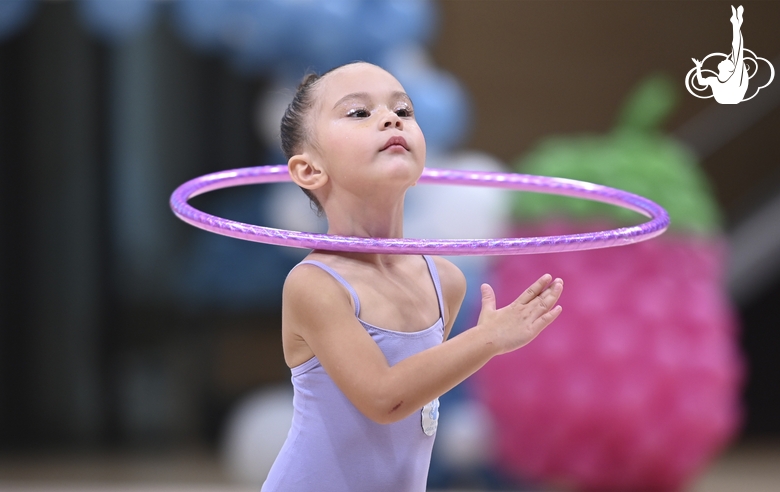 Young gymnast during an exercise with a hoop at the mAlinka tournament