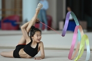 Chinese gymnast performs an exercise with a ribbon