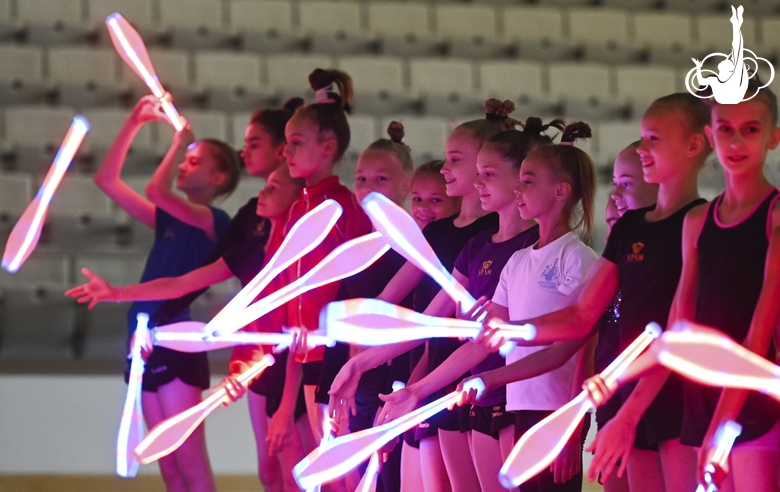 Gymnasts perform tricks with clubs