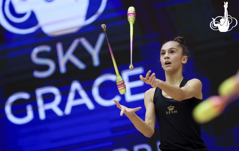 Gymnast during an exercise with clubs at floor testing