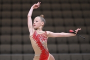 Gymnast does an exercise with clubs