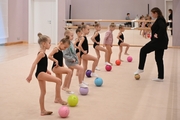 Teacher Anna Pukhova with young gymnasts during a rhythmics class