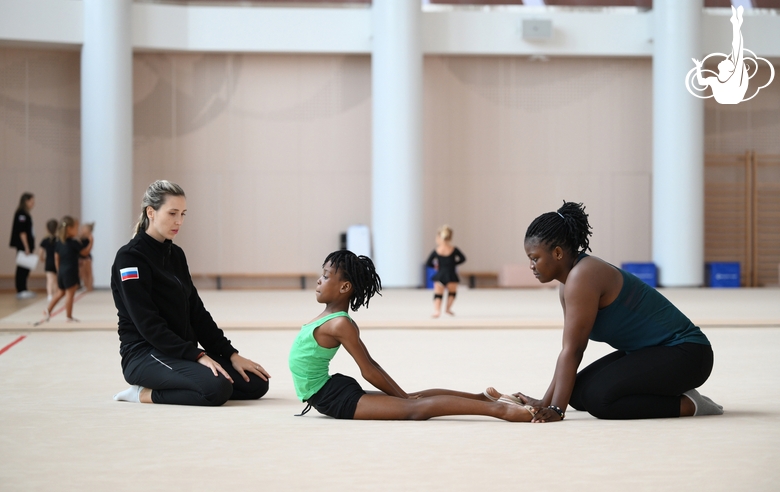 Academy coach Olga Frolova with gymnast Nkenko Sita Davina Chanselvi and coach Dominique Adama from the Republic of Congo during the training session