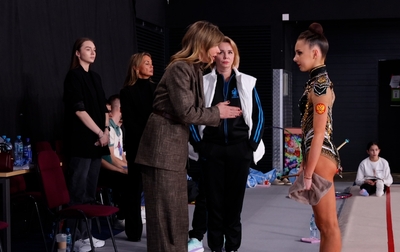 Olympic champion Alina Kabaeva gives instructions to Mariia Borisova ahead of her performance on the second competition day of the tournament in Moscow