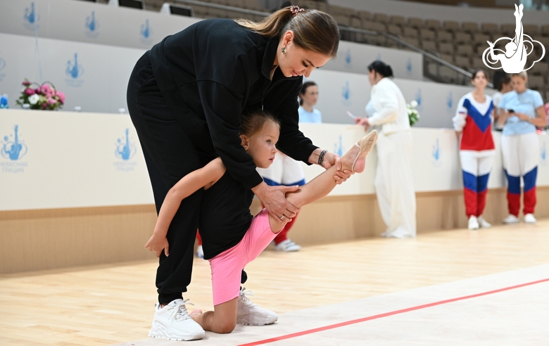 Olympic champion Alina Kabaeva with a young gymnast during selection into the Academy