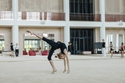 Young gymnast working on an element during training